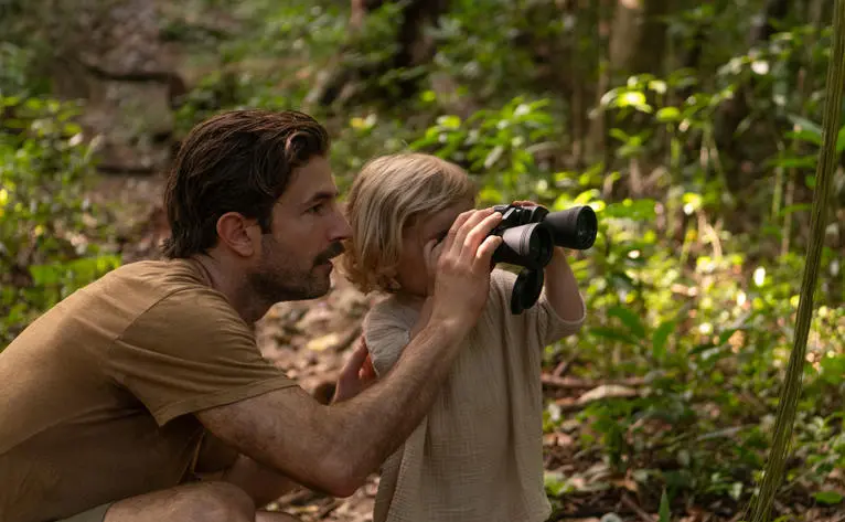 Adult and child birdwatching together at Amanera resort, Dominican Republic.