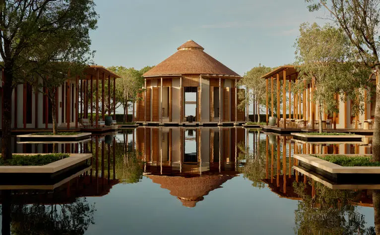 Amanyara resort's main pavilion reflected in still water at sunrise, Turks and Caicos.