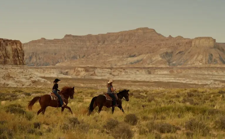 Horseback riders crossing the desert landscape at Amangiri, Utah.