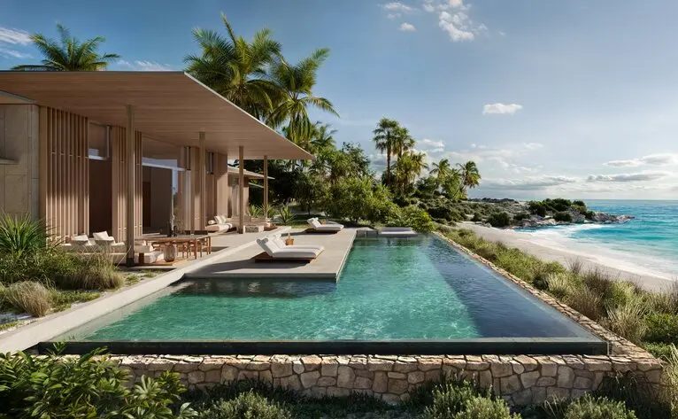 Amancaya residence pool terrace overlooking turquoise waters, with loungers and tropical gardens.