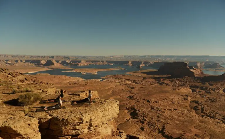Yoga session overlooking Tower Butte and desert landscape at Amangiri resort, Utah.