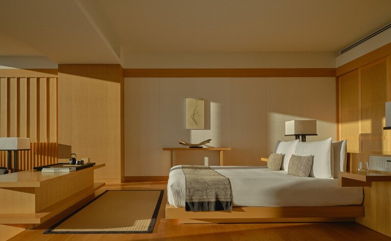 Grand Suite at Aman Tokyo with light wood furniture, low platform bed, and serene minimalist Japanese interior design.