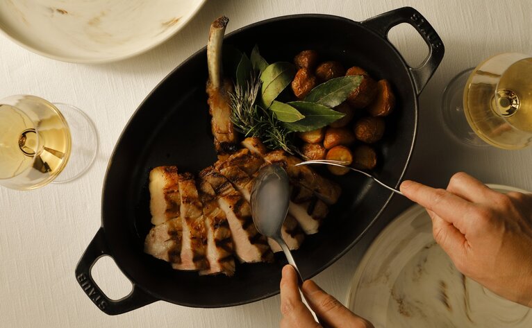 Seared wagyu beef and vegetables in cast iron skillet at Aman Tokyo.