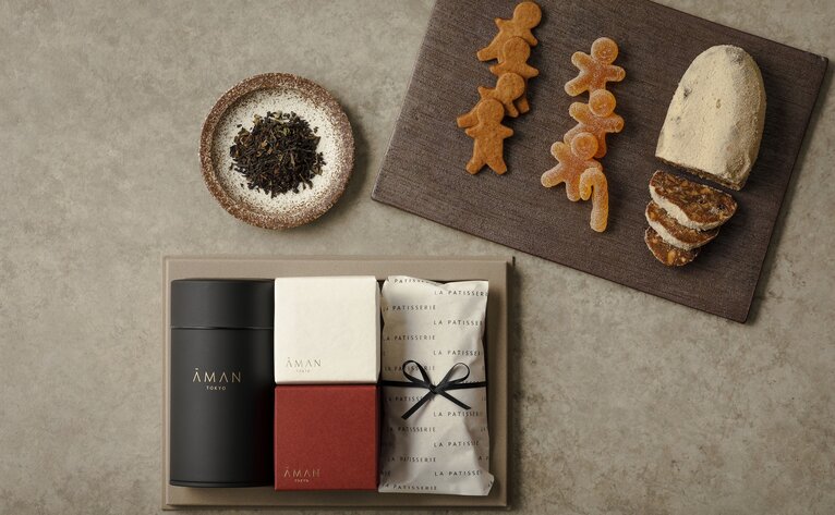 Aman Tokyo Christmas gift box displayed with wrapped presents and festive decorations.