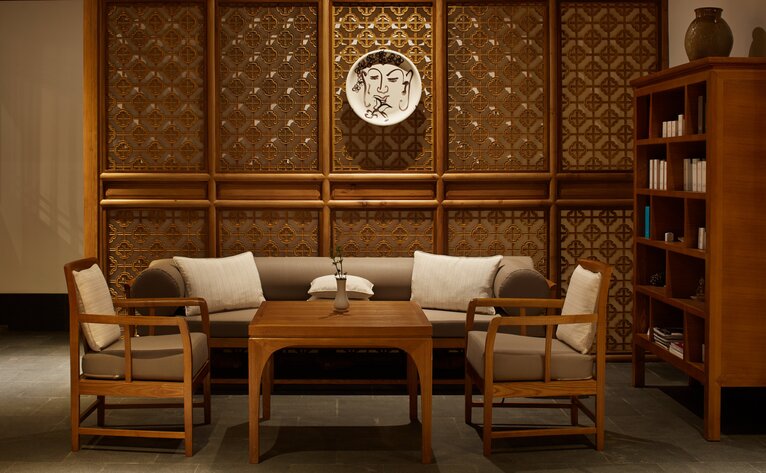 Spa reception area at Amandayan with wooden panelled walls, comfortable seating, and warm ambient lighting.