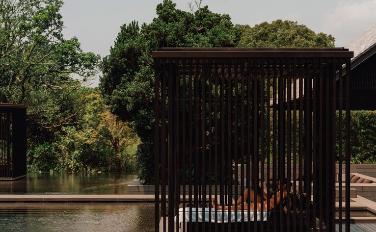 Wooden bathing pavilion beside thermal spring waters at Amanemu, Japan.