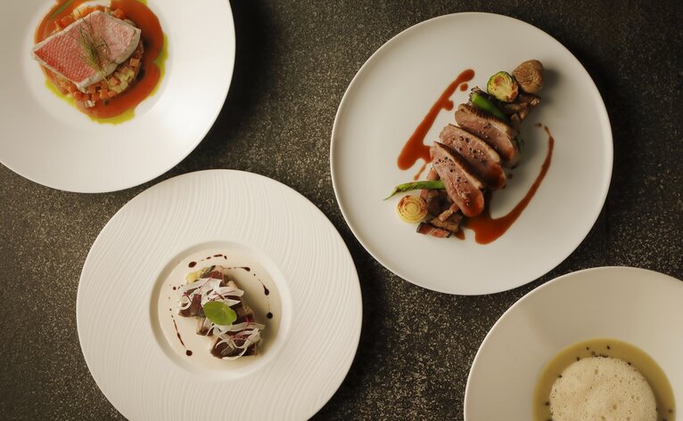 Autumn dishes at Aman Tokyo, featuring plated cuisine with seasonal ingredients artfully presented.
