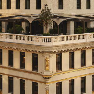 Aman New York's curved exterior facade with classical arched windows and ornamental balustrade.