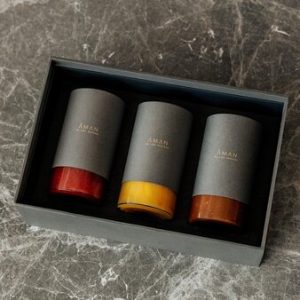 Three jam jars with red, yellow and orange lids in presentation box at Aman Nai Lert Bangkok.