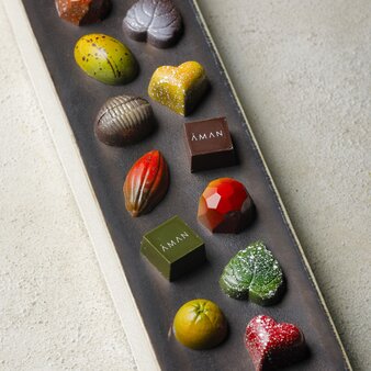 Assorted Japanese confections and sweets displayed on a dark rectangular board at Aman Kyoto.