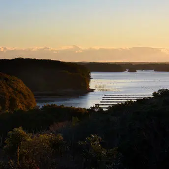 Ago Bay at sunset, Amanemu resort, Japan, with golden light reflecting across calm waters.