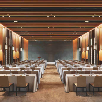 Ballroom at Amanyangyun set for conference with rows of tables, chairs, and projection screen.