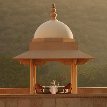 Amanbagh's main building exterior featuring a domed pavilion with terracotta columns and cream dome.