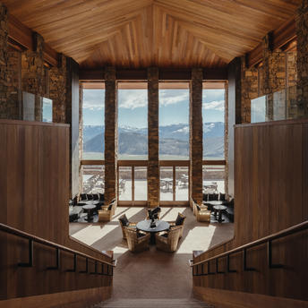 Amangani's lobby features wooden panelling and large windows framing views of Wyoming's landscape.
