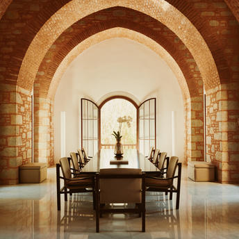 Amanruya's interior meeting room with stone archway, two chairs facing a desk, and central fountain.