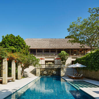 Poolside pavilion with thatched roof and lap pool at Aman Villas at Nusa Dua, Indonesia.