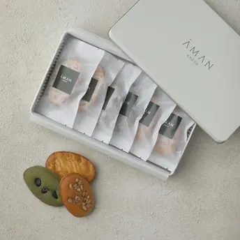 Aman Kyoto resort amenities: white branded toiletries set with decorative ceramic pieces.