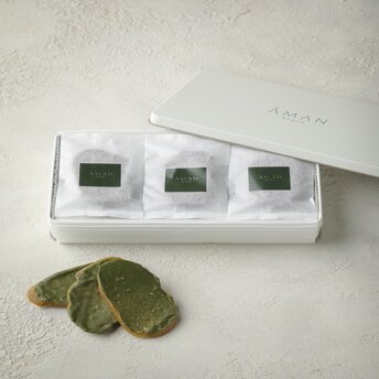 Aman Kyoto matcha green tea rusks displayed with three tasting samples in glass containers.
