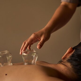 Therapist's hands administering a Vietnamese massage treatment at Amanoi's spa and wellness centre.