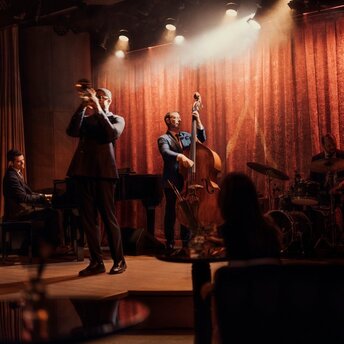 Jazz band performing on stage at The Jazz Club, Aman New York.