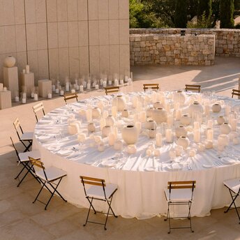 Circular dining table set for a wedding celebration at Amanzoe resort in Greece.